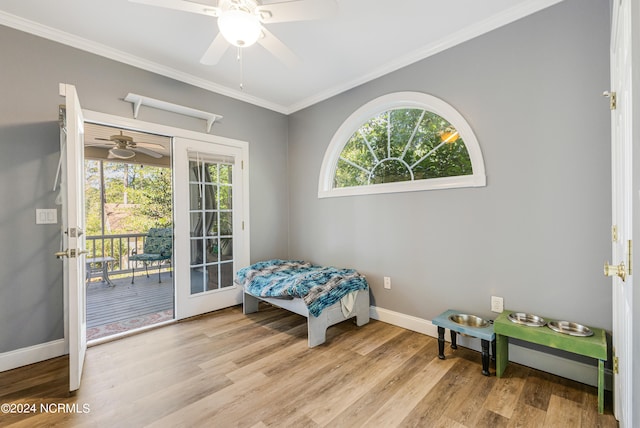 sitting room featuring a wealth of natural light, crown molding, and light wood-type flooring