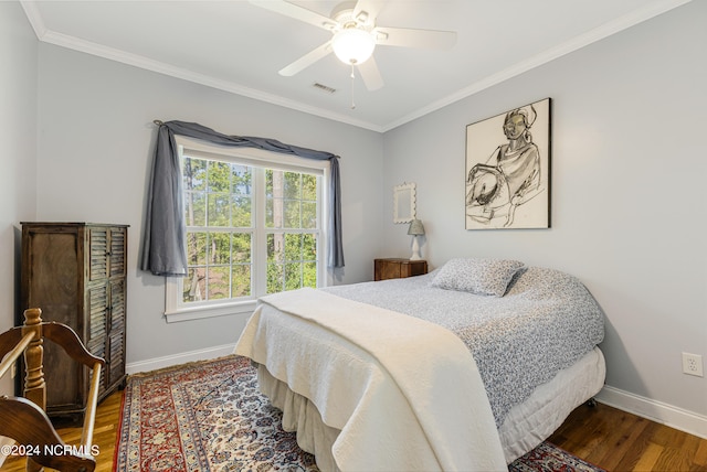 bedroom with hardwood / wood-style floors, crown molding, and ceiling fan