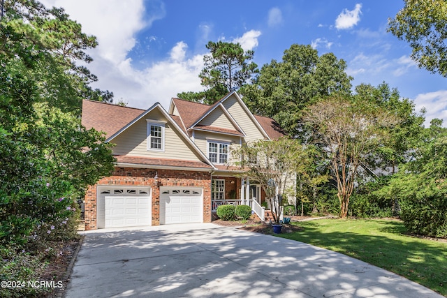 view of front of property featuring a front lawn and a garage