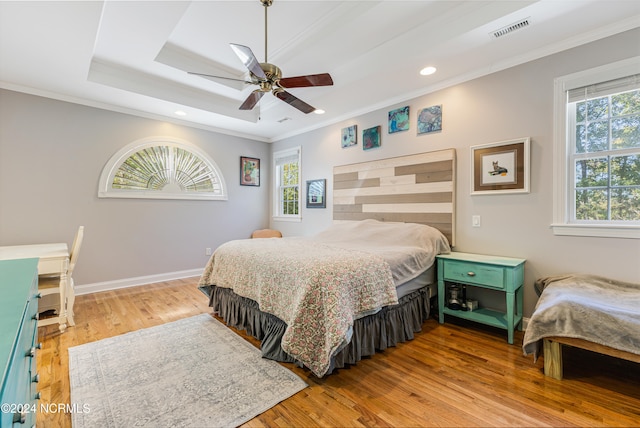 bedroom with light hardwood / wood-style flooring, multiple windows, and ceiling fan