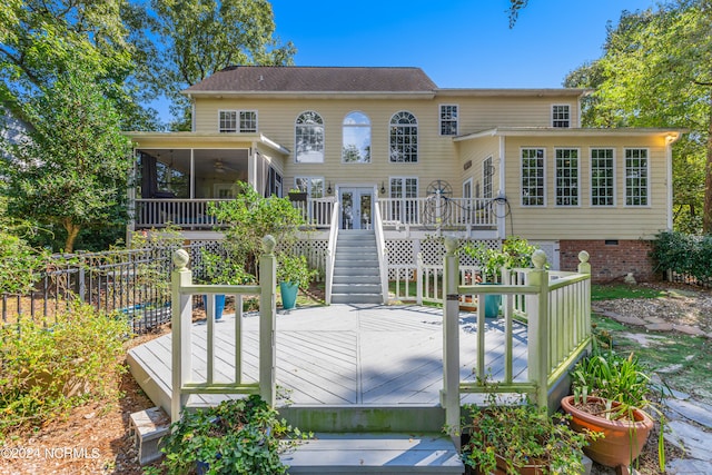 rear view of house with a sunroom and a deck