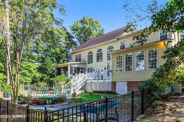 back of property featuring a covered pool and a sunroom