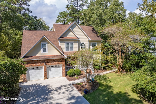 view of front of property with a front lawn and a garage