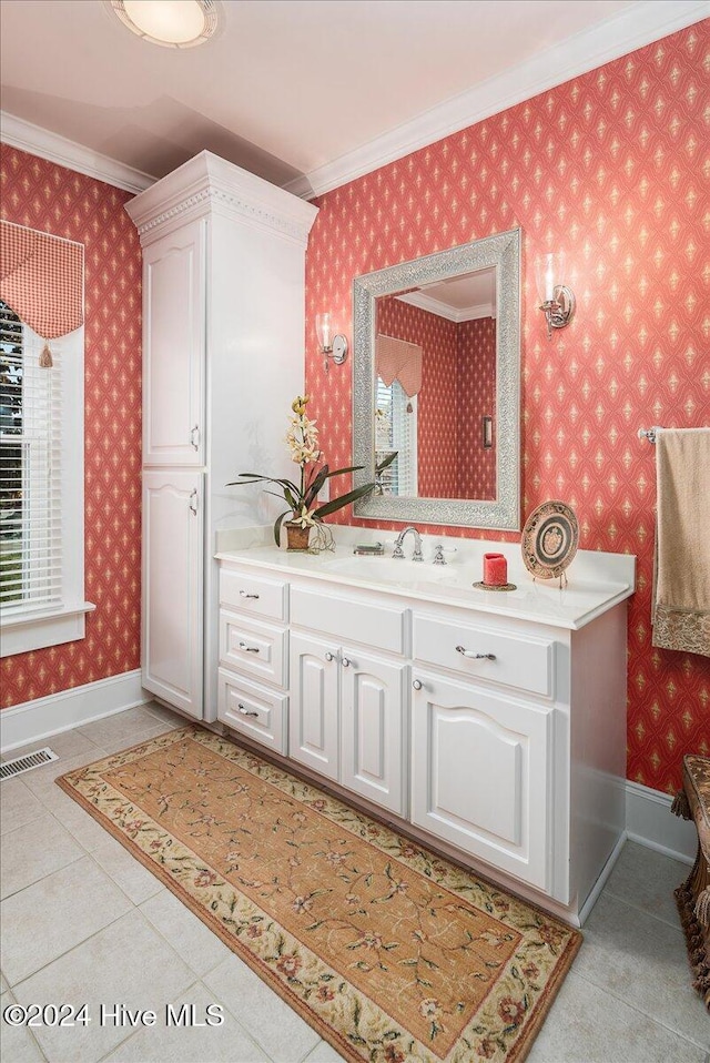 bathroom featuring tile patterned flooring, vanity, and crown molding