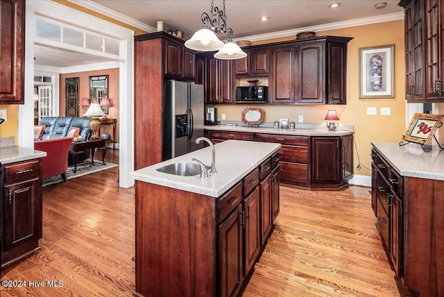 kitchen featuring a center island with sink, stainless steel fridge with ice dispenser, ornamental molding, pendant lighting, and light wood-type flooring