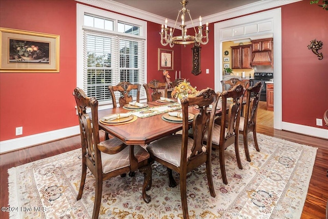 dining space with a chandelier, hardwood / wood-style floors, and ornamental molding