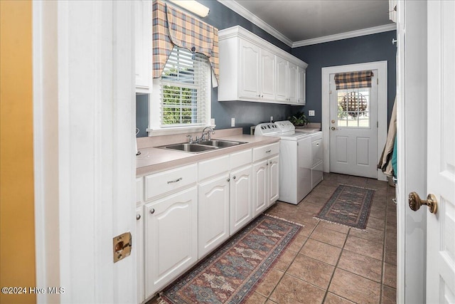 laundry area featuring cabinets, separate washer and dryer, a wealth of natural light, and sink