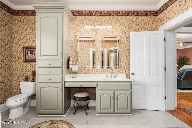 bathroom with ornamental molding, hardwood / wood-style floors, vanity, and toilet