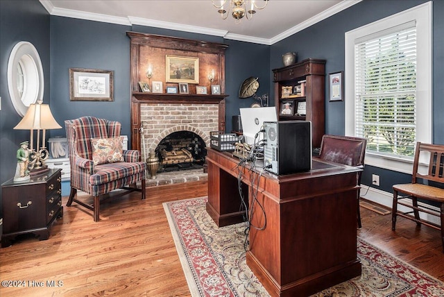 office space with light wood-type flooring, a wealth of natural light, and crown molding