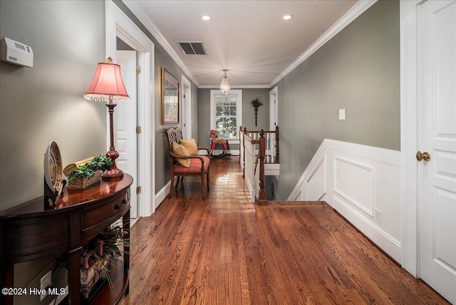 hallway with dark hardwood / wood-style floors and crown molding