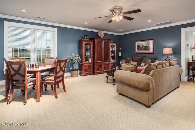 carpeted living room with ornamental molding and ceiling fan