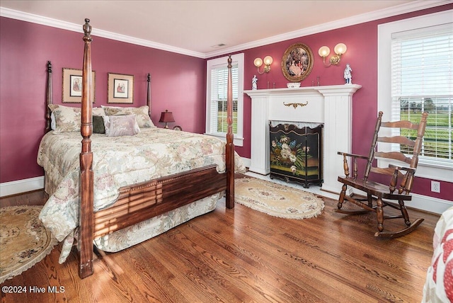 bedroom featuring wood-type flooring and ornamental molding