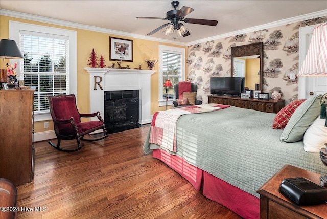 bedroom featuring dark wood-type flooring, ceiling fan, multiple windows, and ornamental molding