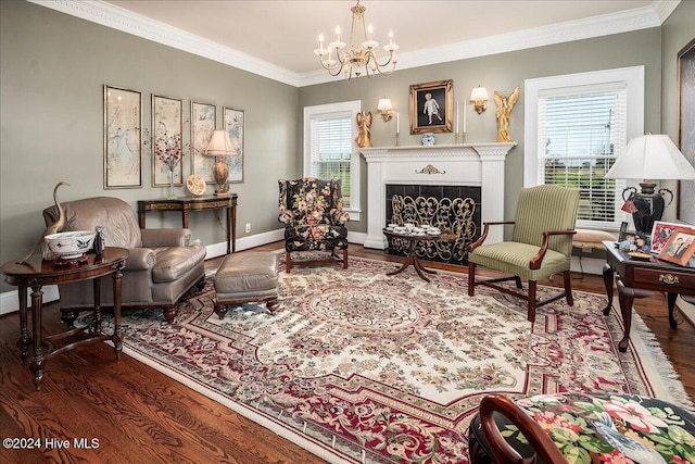 sitting room featuring wood-type flooring, plenty of natural light, a chandelier, and ornamental molding