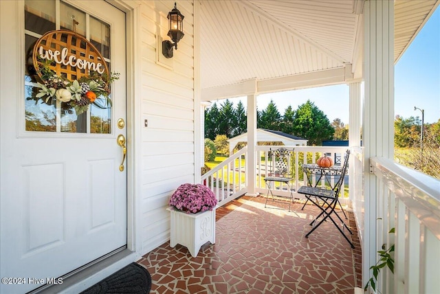 view of exterior entry with a porch