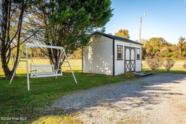 view of outbuilding featuring a yard