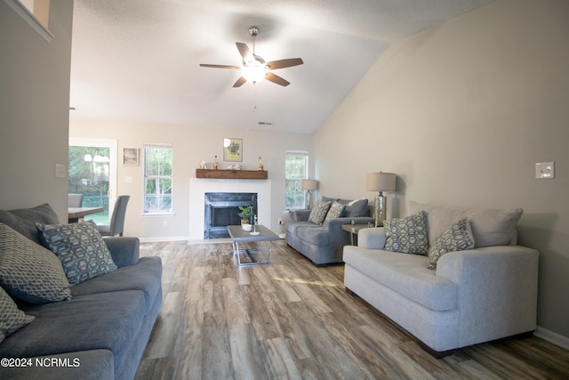 living room featuring ceiling fan, lofted ceiling, and hardwood / wood-style flooring