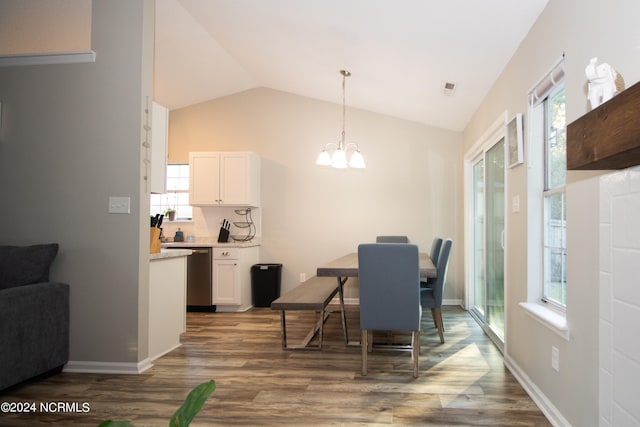 dining area with plenty of natural light, vaulted ceiling, and dark hardwood / wood-style flooring