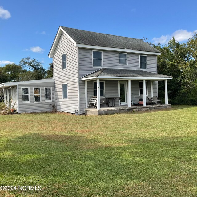 view of front of home with a front yard and covered porch