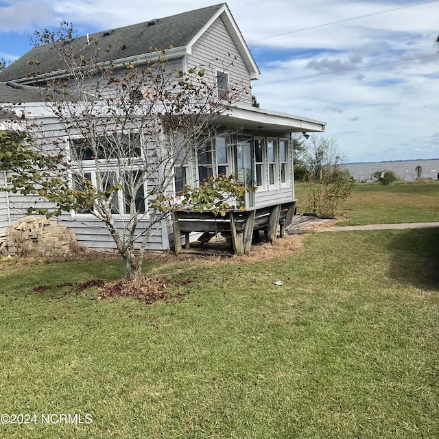 view of side of home featuring a yard