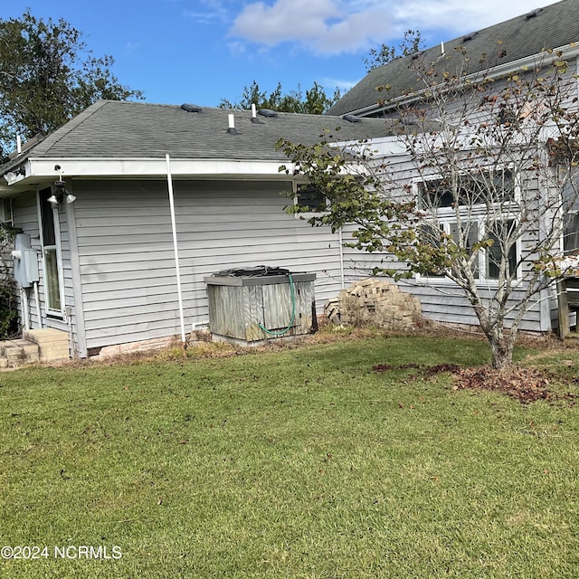 view of side of home featuring a lawn