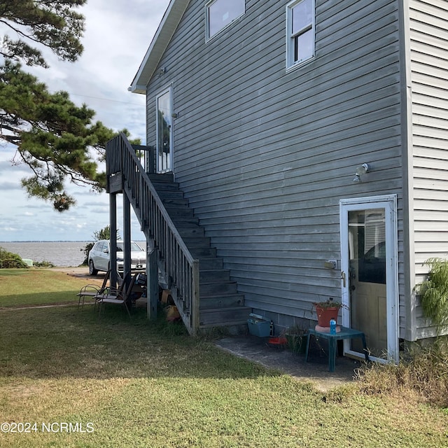 view of side of home with a yard