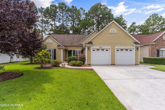 view of front of property featuring a garage and a front yard