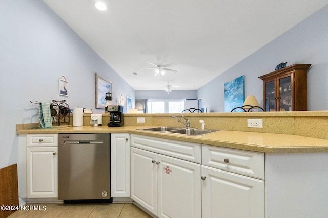 kitchen with light tile patterned flooring, ceiling fan, sink, stainless steel dishwasher, and white cabinetry