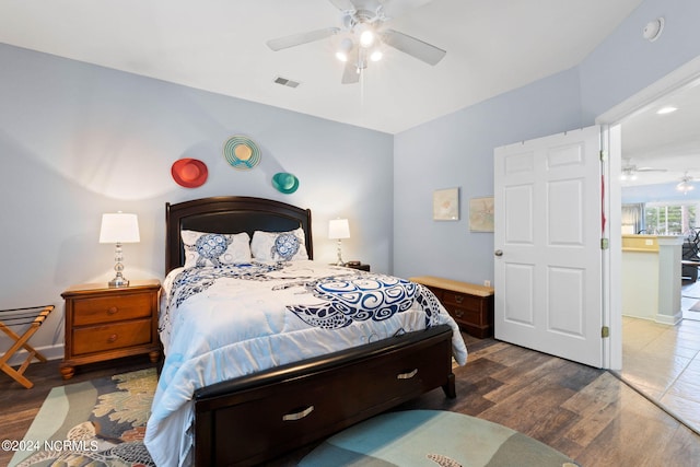 bedroom with ceiling fan and dark hardwood / wood-style floors