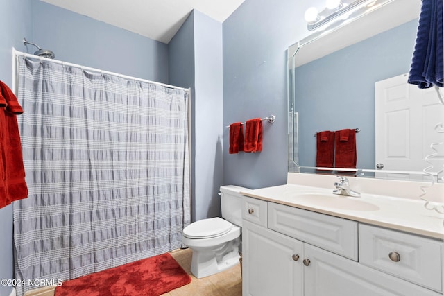 bathroom featuring vanity, toilet, and a shower with shower curtain