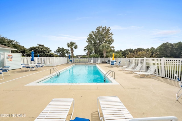 view of swimming pool featuring a patio area