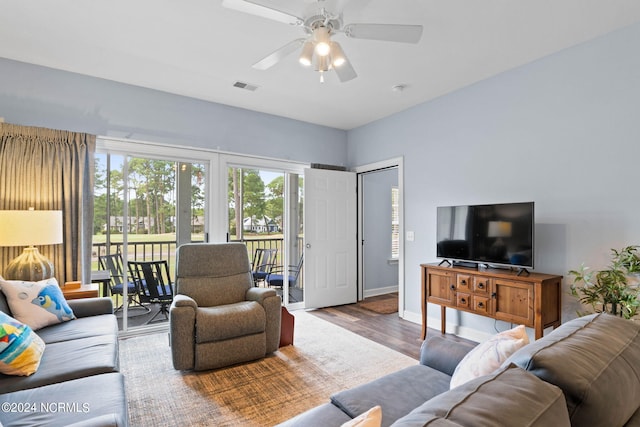 living room featuring ceiling fan and hardwood / wood-style floors