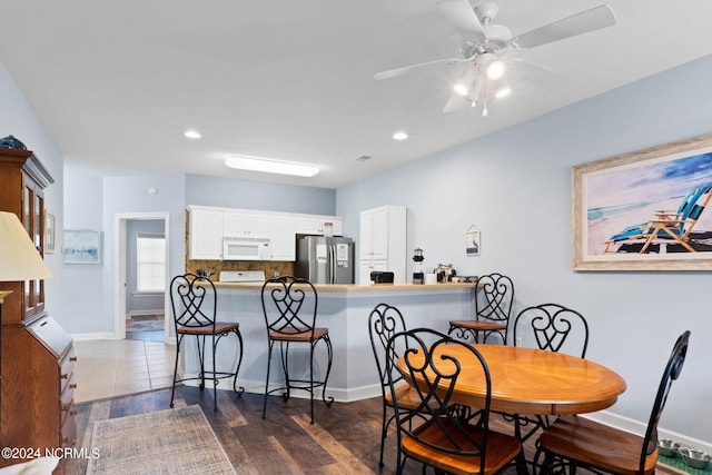 dining area with ceiling fan and hardwood / wood-style floors