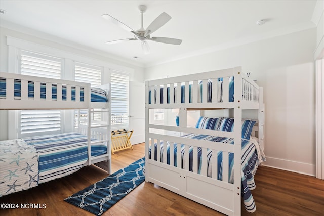 bedroom with visible vents, ceiling fan, baseboards, and wood finished floors