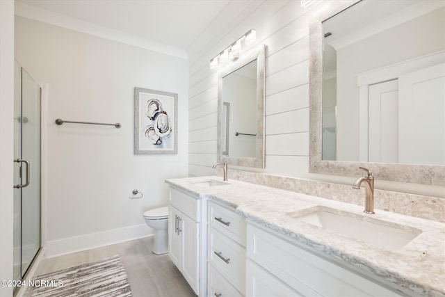 full bathroom featuring toilet, a stall shower, and a sink