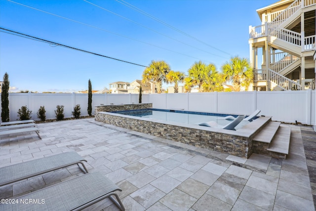 view of patio featuring stairway, a fenced in pool, and a fenced backyard