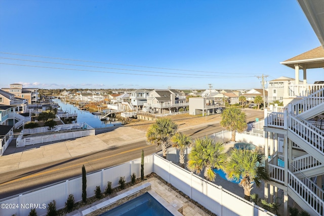 view of water feature with a residential view and a fenced backyard