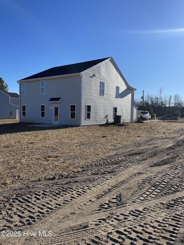 back of house with central AC