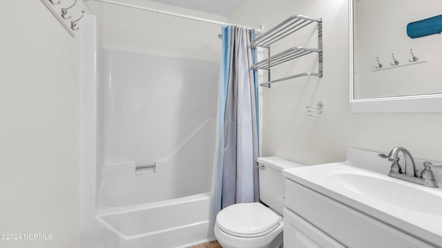 full bathroom with vanity, shower / bath combo with shower curtain, and toilet