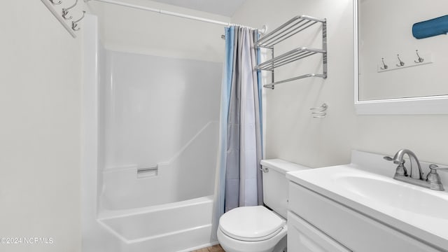 full bath with vanity, shower / tub combo, and toilet