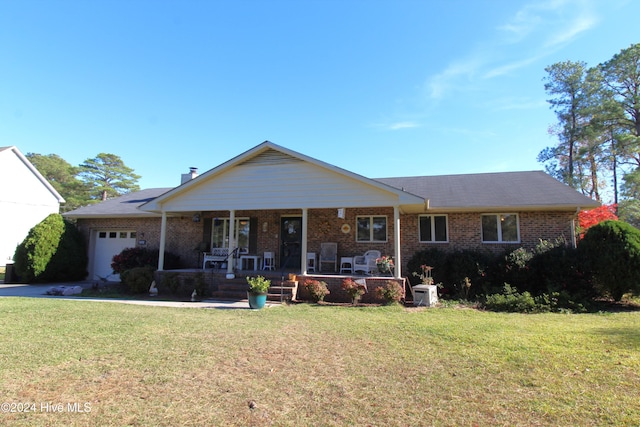 ranch-style home with covered porch, a garage, and a front lawn