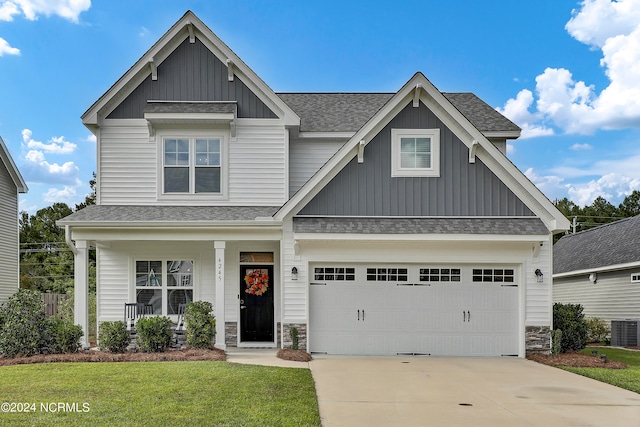 craftsman-style house with a front yard, a garage, a porch, and central AC unit