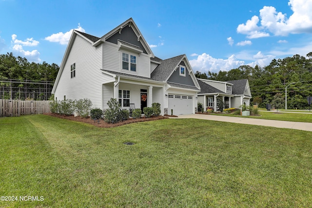 craftsman inspired home with a front yard and a garage