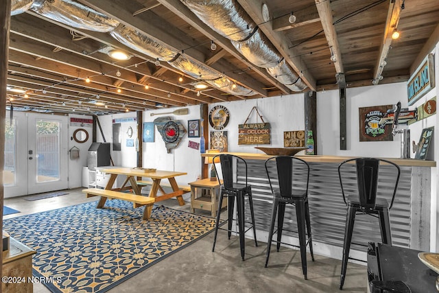 basement with french doors and indoor bar