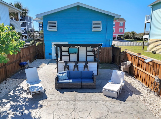 back of house featuring a patio area, a balcony, and outdoor lounge area