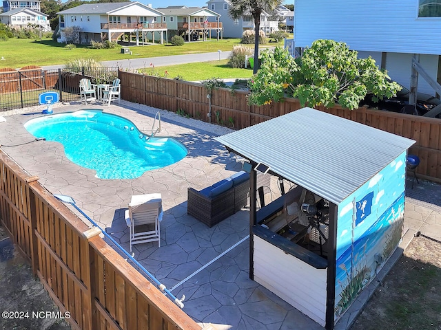 view of pool featuring a patio and a yard