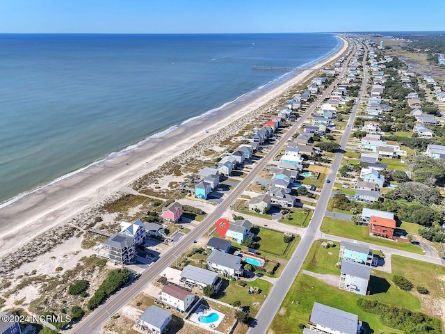 drone / aerial view featuring a water view and a beach view