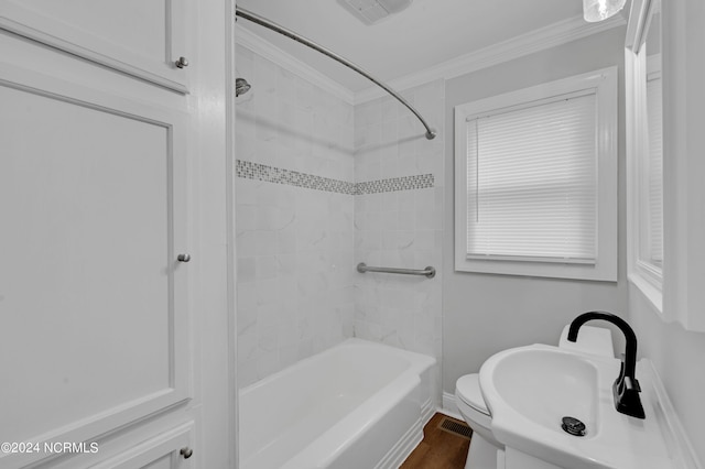 bathroom with crown molding, toilet, shower / bath combination, wood finished floors, and visible vents