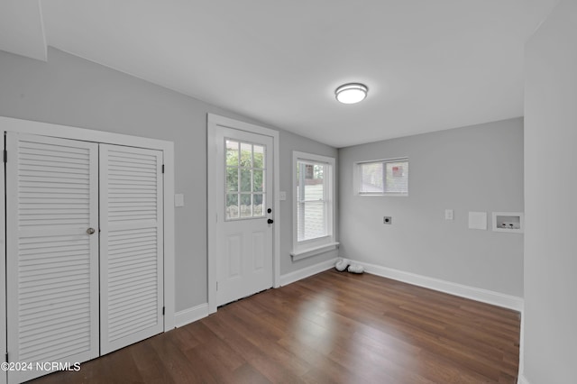foyer entrance with baseboards, plenty of natural light, and dark wood-style flooring