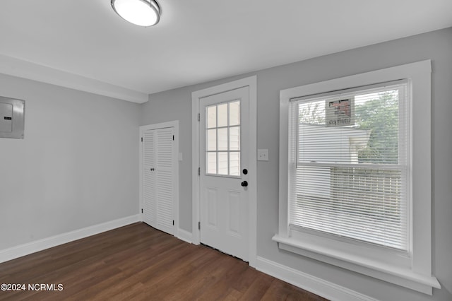 entryway with baseboards, electric panel, and dark wood-style flooring